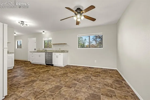 a view of kitchen with microwave and white cabinets