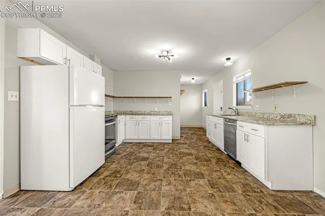 a kitchen with white cabinets and white appliances