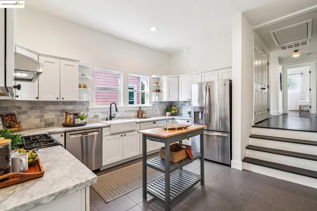 a view of a hallway with wooden floor windows and a living room