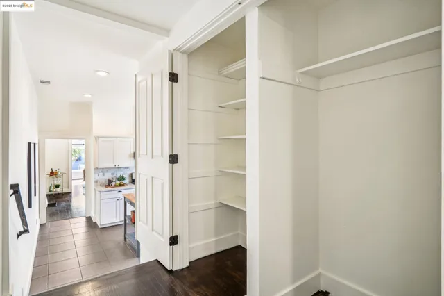 a bathroom with a granite countertop toilet sink and mirror