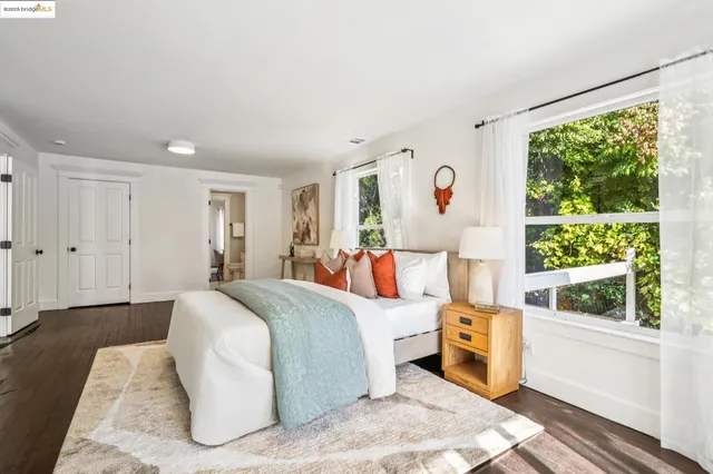 a view of a livingroom with wooden floor and furniture
