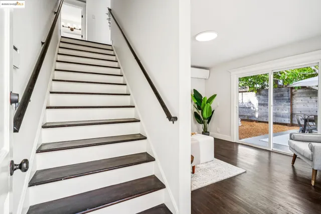 a bedroom with bed and wooden floor