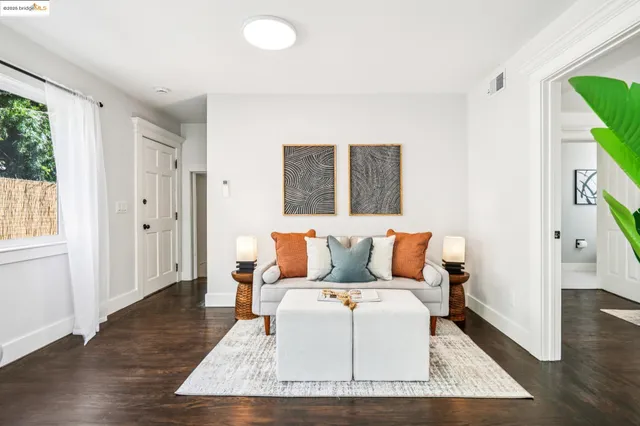 a living room with furniture rug and a table