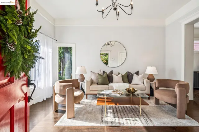 a view of a dining room with furniture a chandelier and wooden floor