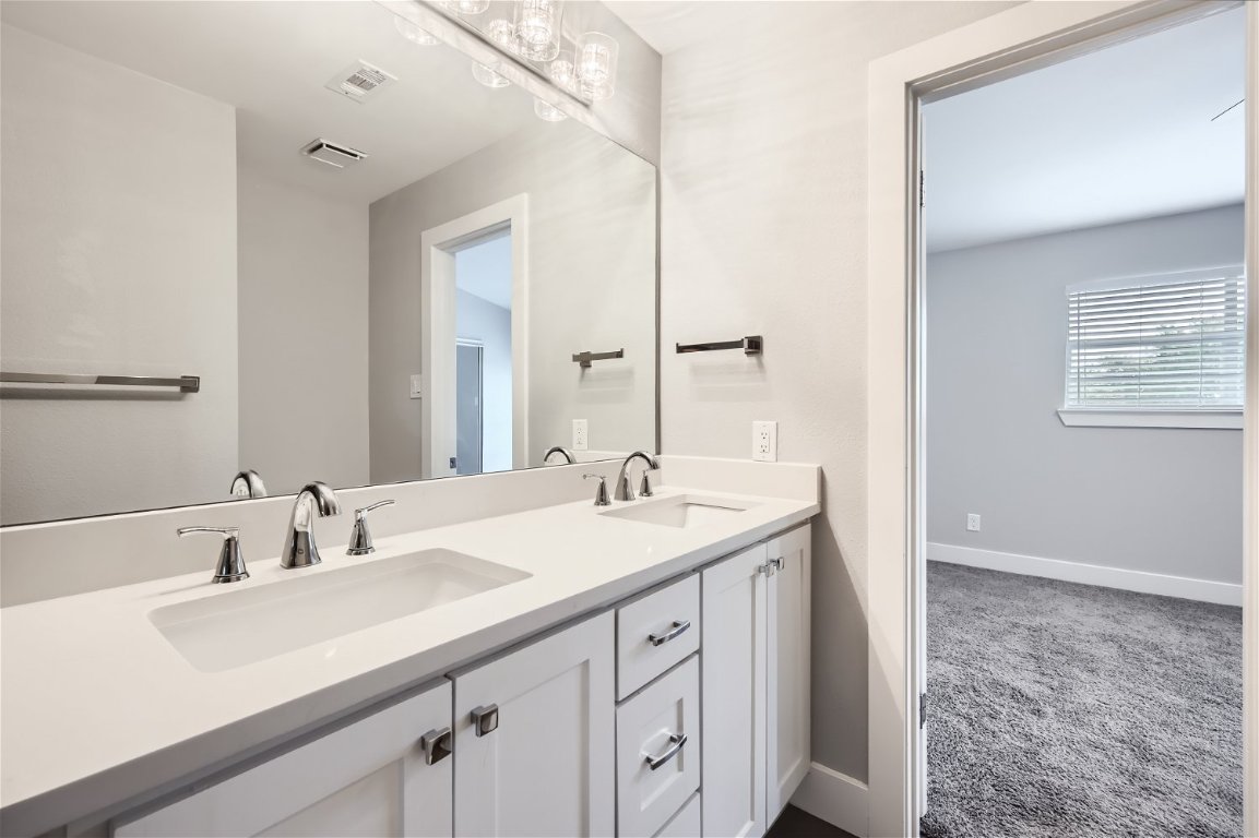 1830 River Crossing Circle, Unit D Austin, TX 78741 - Photo 14 of 27 a bathroom with a sink and a mirror