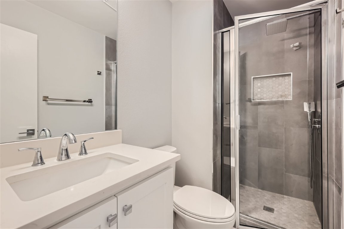 1830 River Crossing Circle, Unit D Austin, TX 78741 - Photo 16 of 27 a bathroom with a sink a toilet and shower