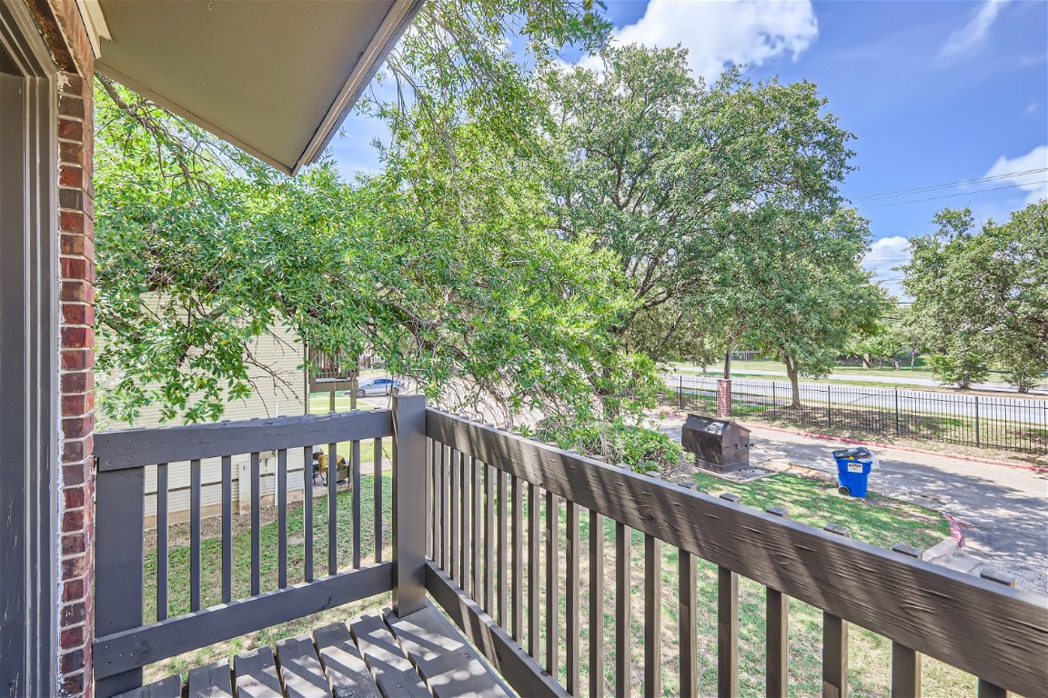 1830 River Crossing Circle, Unit D Austin, TX 78741 - Photo 19 of 27 a view of a balcony with wooden floor