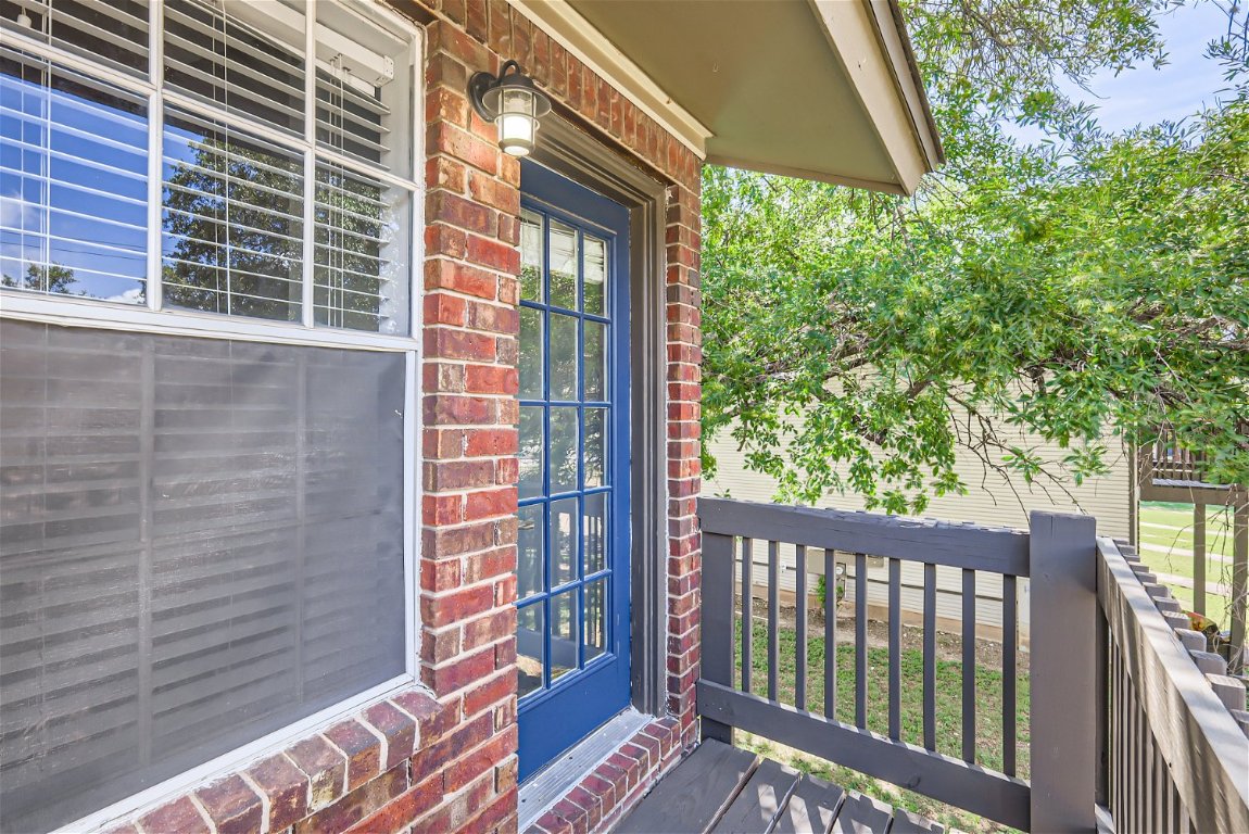 1830 River Crossing Circle, Unit D Austin, TX 78741 - Photo 20 of 27 a view of a balcony with a floor to ceiling window and wooden fence