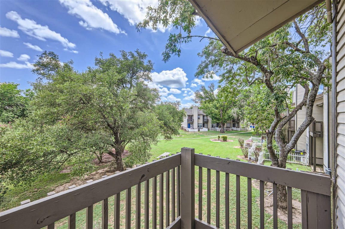1830 River Crossing Circle, Unit D Austin, TX 78741 - Photo 21 of 27 a balcony with trees in front of it