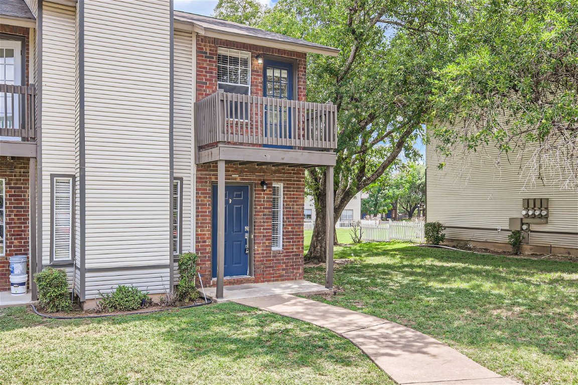 1830 River Crossing Circle, Unit D Austin, TX 78741 - Photo 26 of 27 a view of a house with yard and a garden