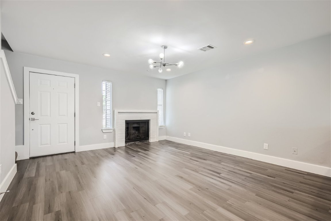 1830 River Crossing Circle, Unit D Austin, TX 78741 - Photo 4 of 27 wooden floor in an empty room with a window