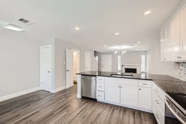 a kitchen with granite countertop a sink and cabinets