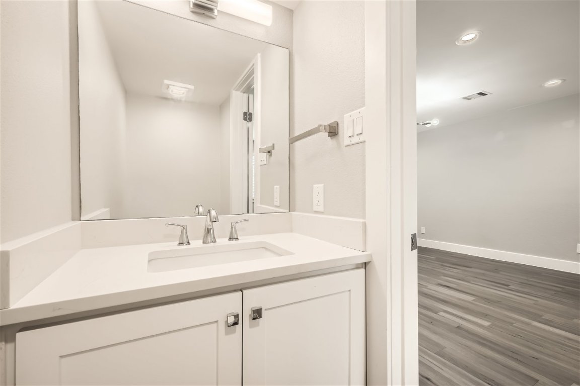 1830 River Crossing Circle, Unit D Austin, TX 78741 - Photo 9 of 27 a bathroom with a sink and a mirror