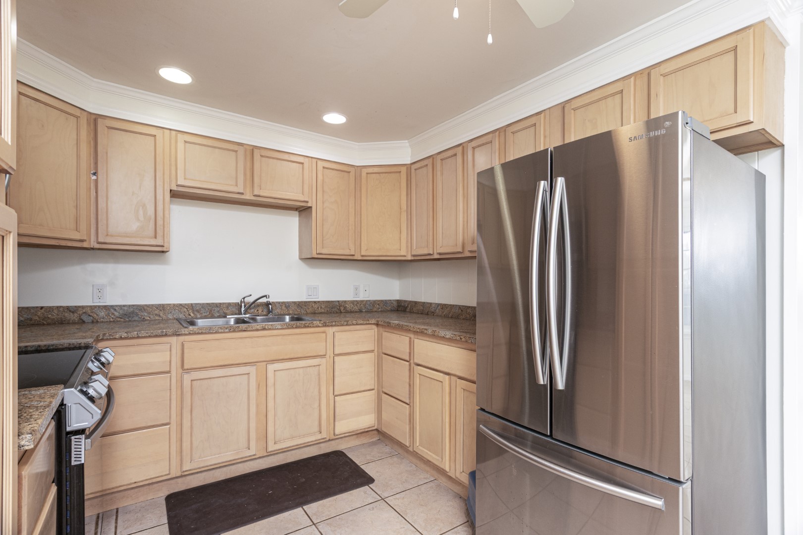 4580 Mamane Street Kapaa, HI 96746 - Photo 5 of 30 a kitchen with stainless steel appliances granite countertop a refrigerator and a stove top oven