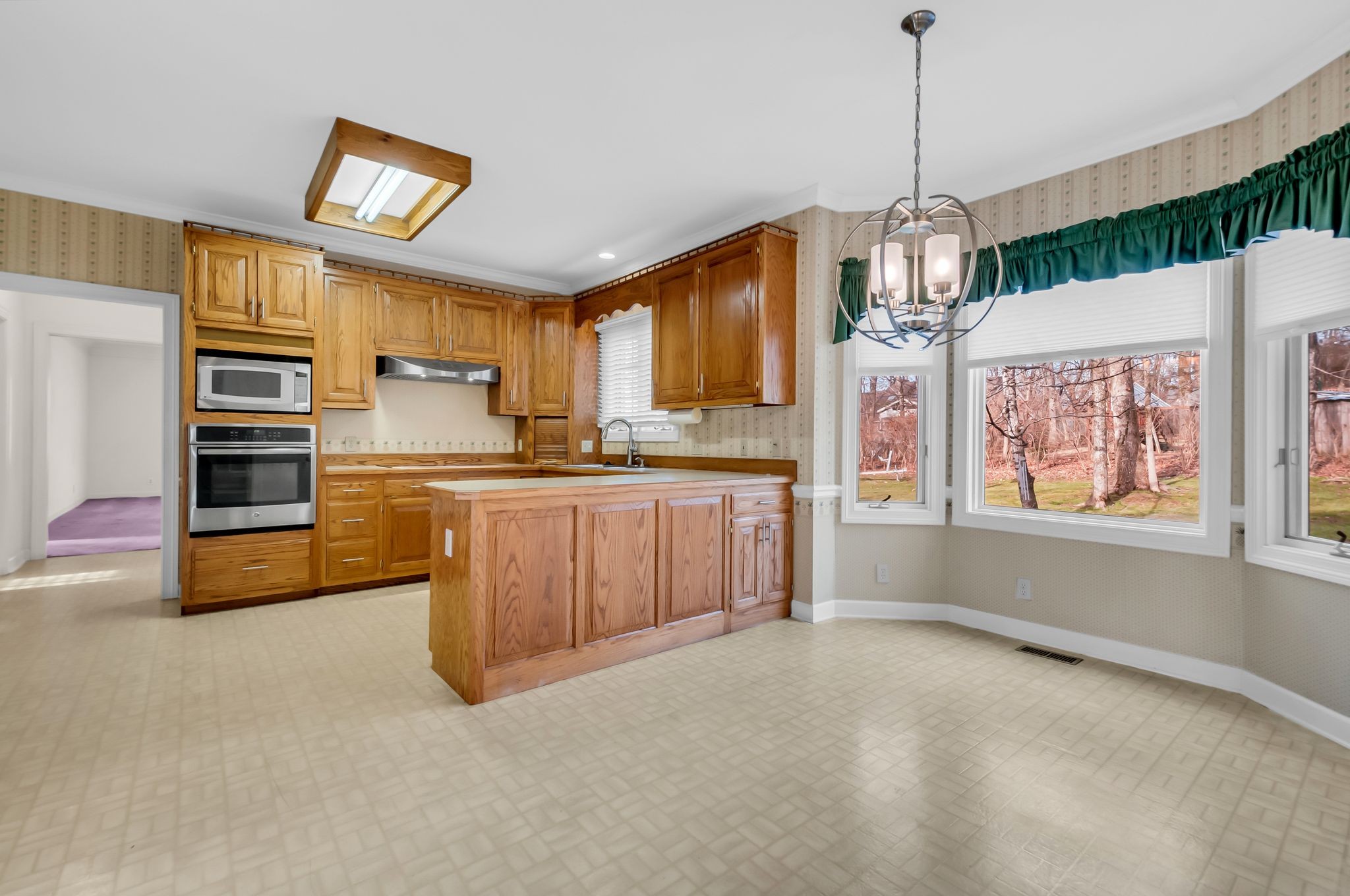 608 Cheshire Circle Franklin, TN 37069 - Photo 12 of 42 a kitchen with stainless steel appliances granite countertop a stove a sink dishwasher a refrigerator and a fireplace with wooden floor