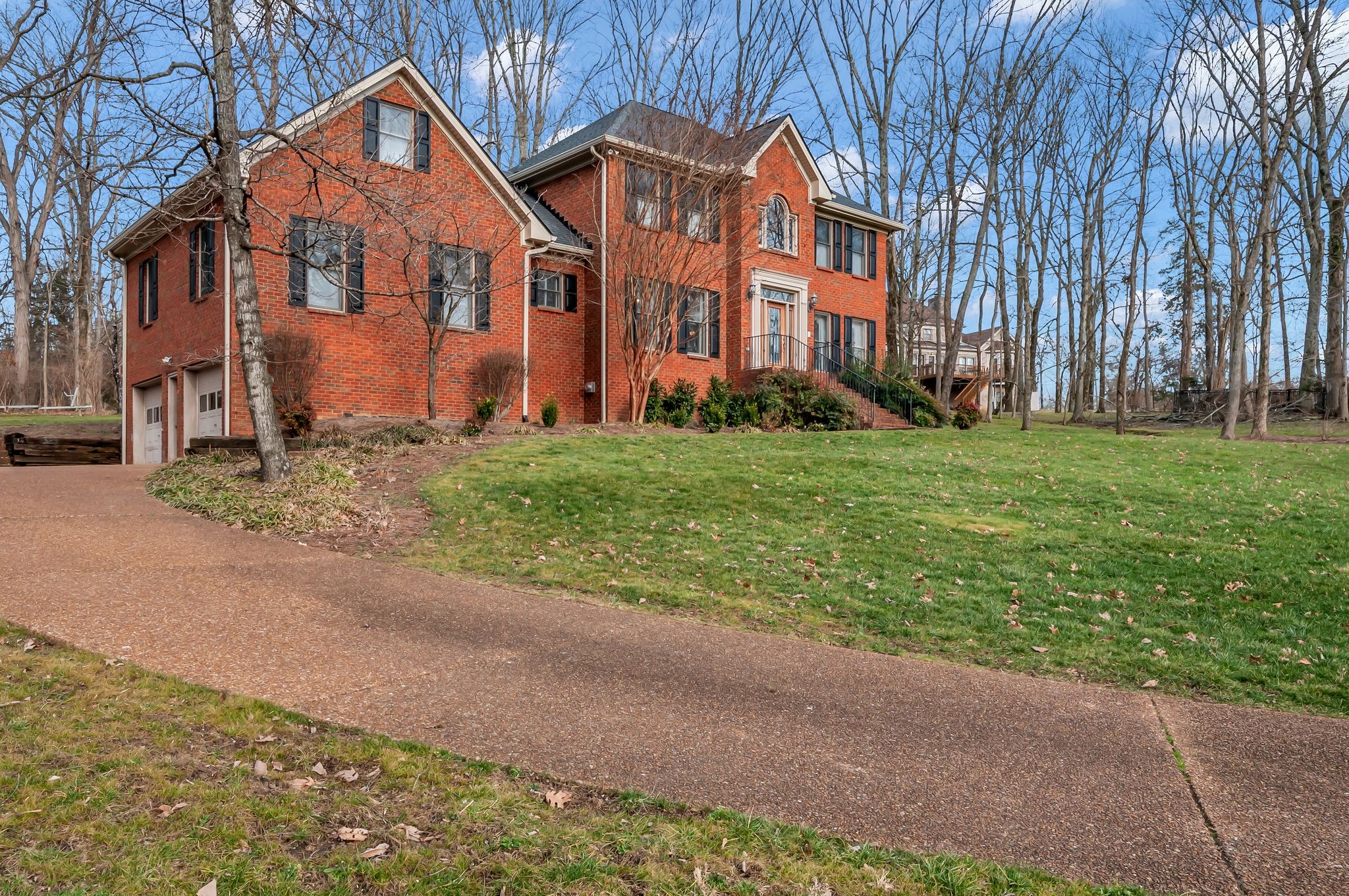 608 Cheshire Circle Franklin, TN 37069 - Photo 2 of 42 a view of a big yard in front of a brick house with large windows