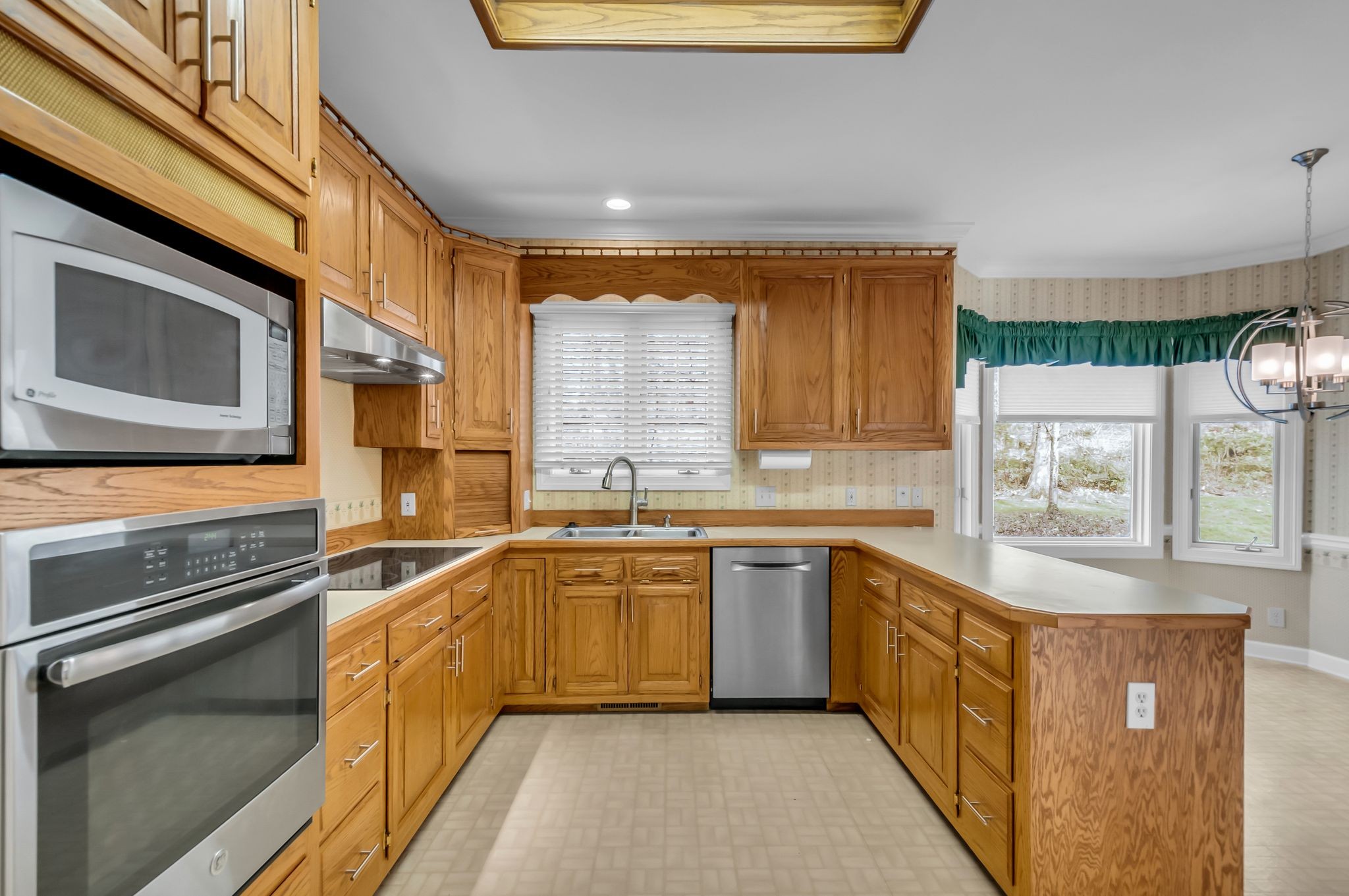 608 Cheshire Circle Franklin, TN 37069 - Photo 22 of 42 a kitchen with stainless steel appliances granite countertop a sink and dishwasher a stove top oven with wooden floor