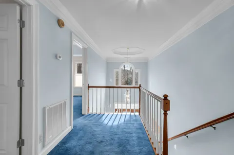 a view of a hallway with wooden floor and entryway