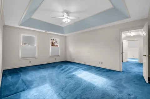 a view of an empty room with closet and chandelier fan