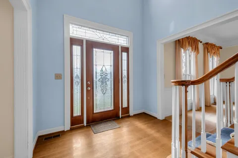 a view of an entryway with wooden floor