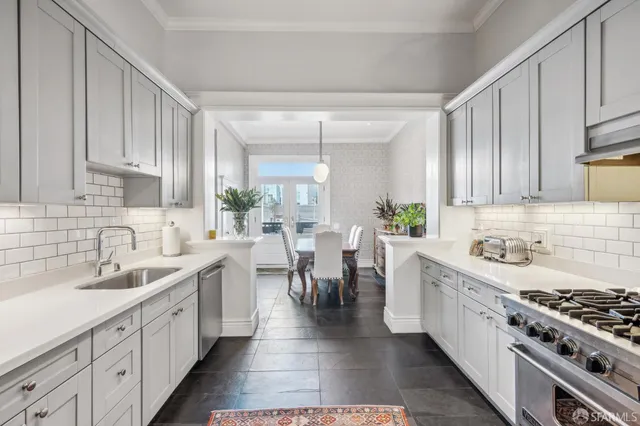 a kitchen with a sink stove and cabinets
