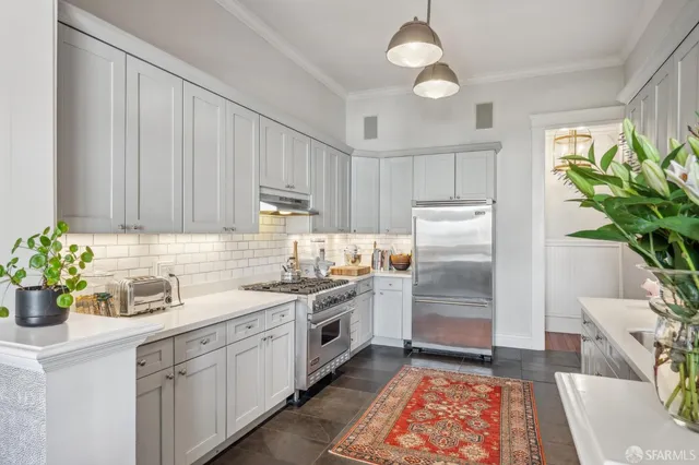 a kitchen with a white stove top oven and refrigerator