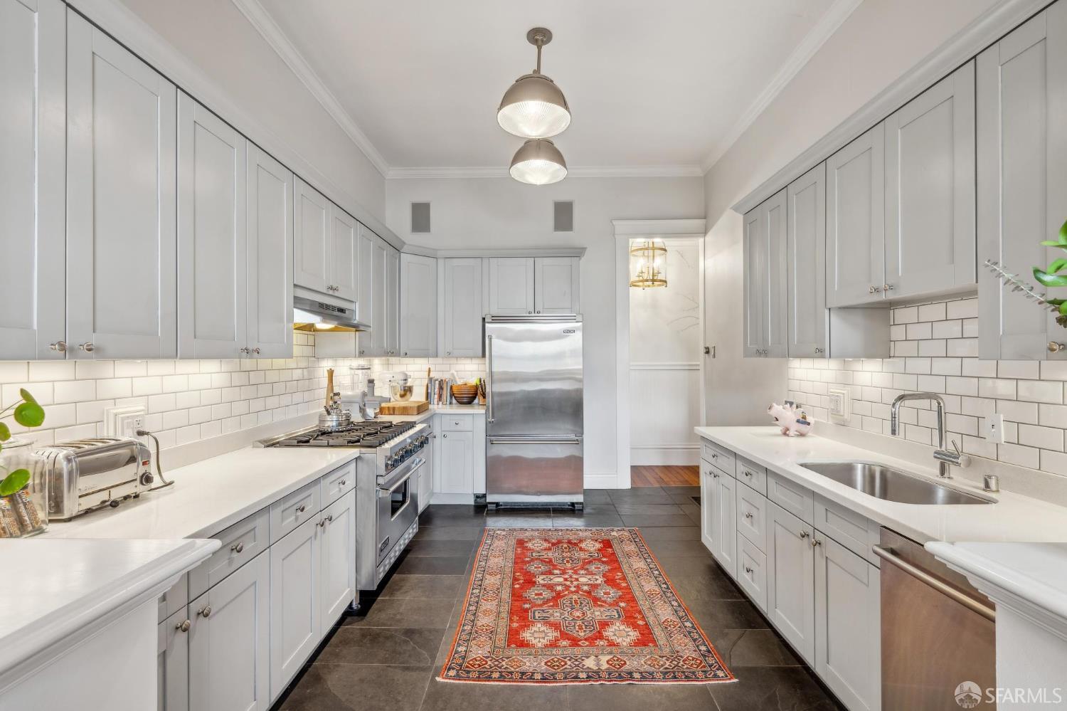 276 Page Street San Francisco, CA 94102 - Photo 15 of 25 a kitchen with lot of cabinets and sink