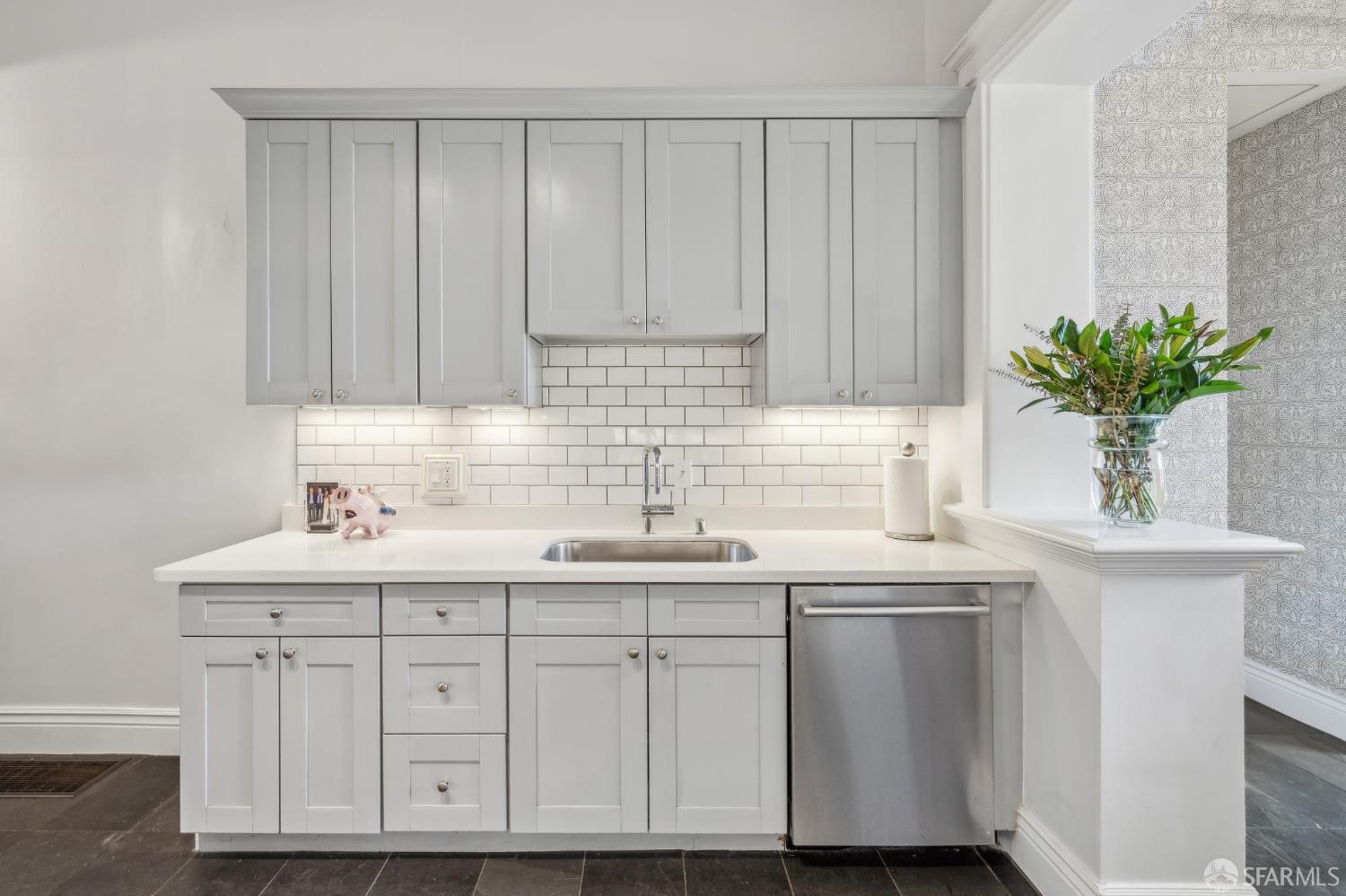276 Page Street San Francisco, CA 94102 - Photo 17 of 25 a kitchen with a sink and cabinets