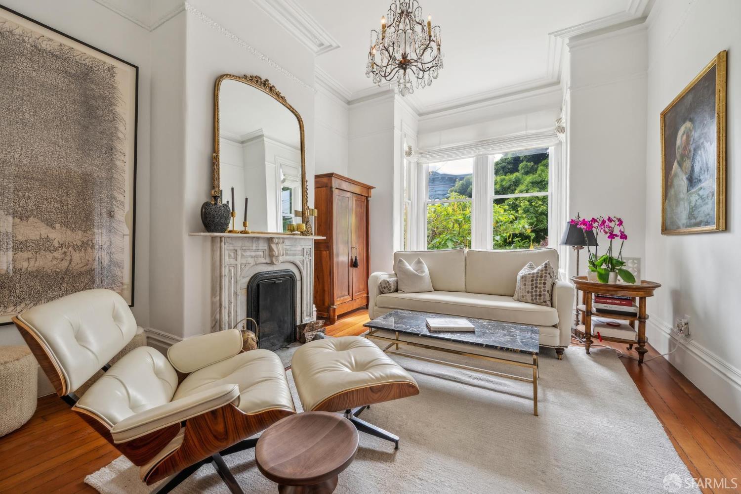 276 Page Street San Francisco, CA 94102 - Photo 3 of 25 a living room with furniture a fireplace and a chandelier