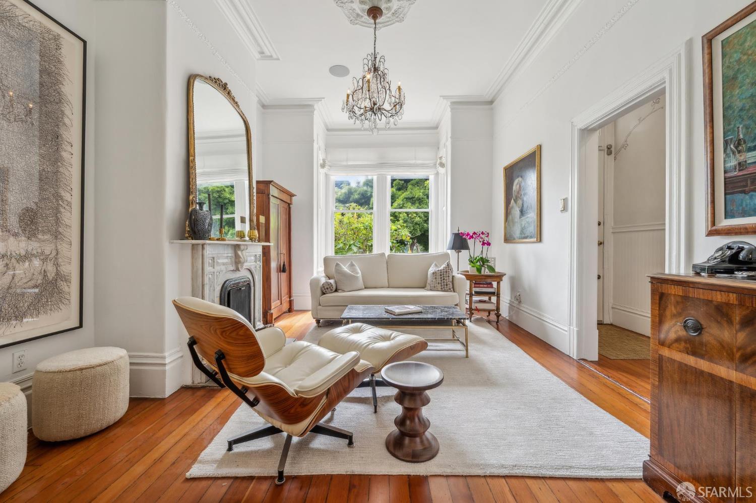 276 Page Street San Francisco, CA 94102 - Photo 4 of 25 a living room with furniture a dining table and a chandelier