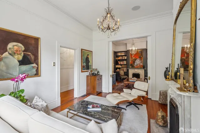 a bedroom with a bed and chandelier