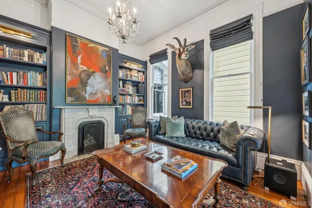 a living room with furniture a rug and a fireplace