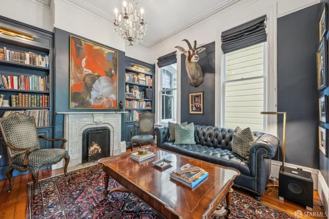 a living room with furniture a rug and a fireplace