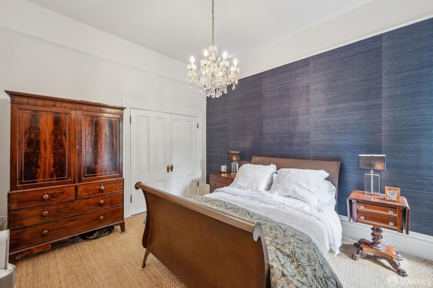 276 Page Street San Francisco, CA 94102 - Photo 10 of 25 a bedroom with a bed and a chandelier