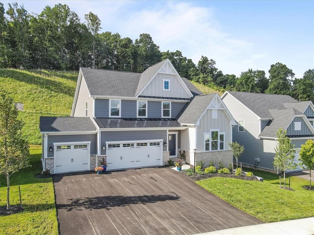 345 Crest Lane Mars, PA 16046 - Photo 2 of 42 a front view of a house with a yard and garage