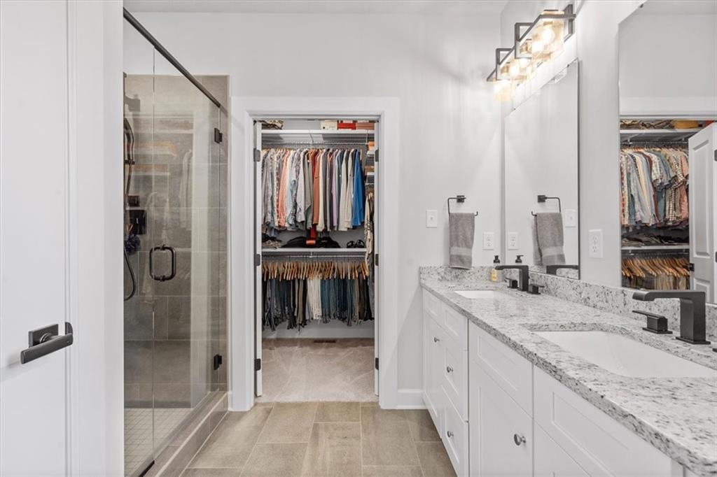 345 Crest Lane Mars, PA 16046 - Photo 25 of 42 a spacious bathroom with a granite countertop sink a mirror and shower