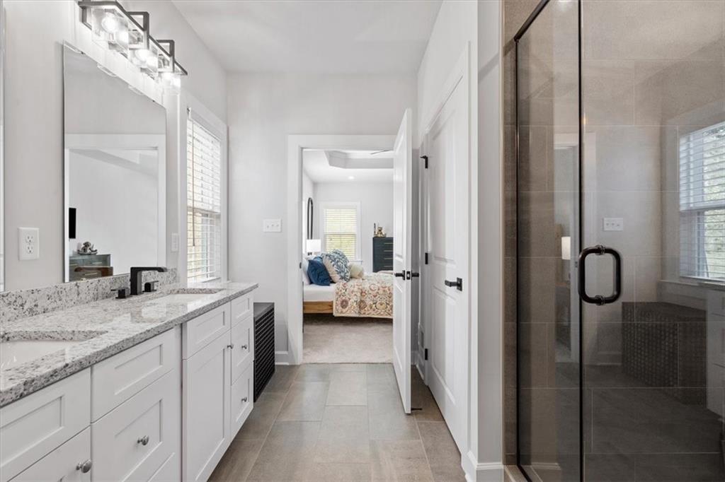 345 Crest Lane Mars, PA 16046 - Photo 26 of 42 a en suite bathroom with a granite countertop double vanity sink a mirror and shower