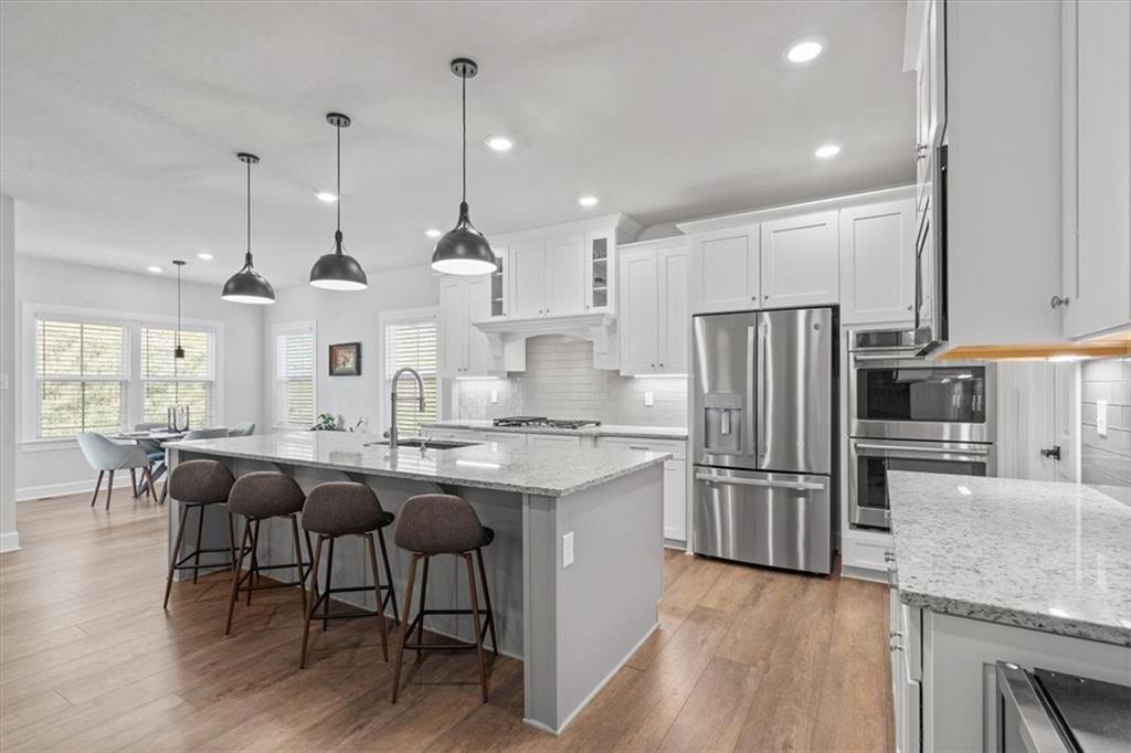 345 Crest Lane Mars, PA 16046 - Photo 4 of 42 a kitchen with stainless steel appliances granite countertop a table chairs stove and refrigerator
