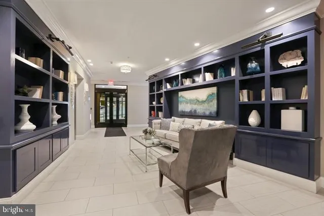 a living room with furniture a flat screen tv and a book shelf