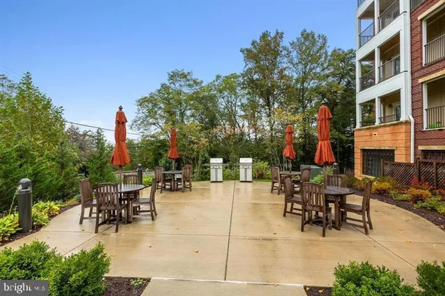 a view of a patio with a table and chairs and potted plants