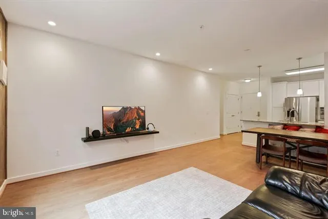 a room with furniture pool table and a flat screen tv