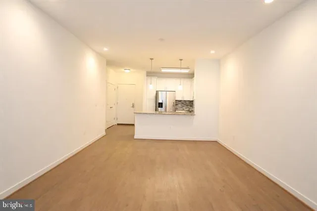 a view of a kitchen with a sink and a refrigerator