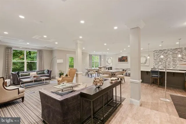 a view of a kitchen with kitchen island a sink stainless steel appliances and a counter top space