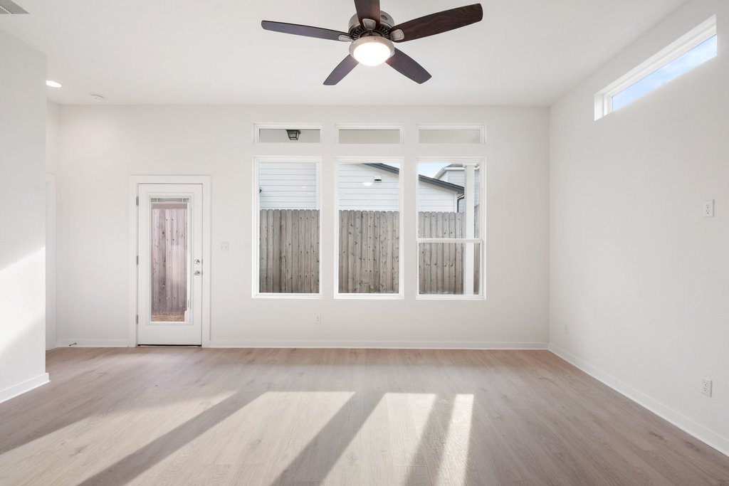 2205 Cento Walk Round Rock, TX 78664 - Photo 7 of 35 Unfurnished room featuring ceiling fan and light wood-style floors