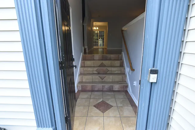 a view of staircase with white walls and windows