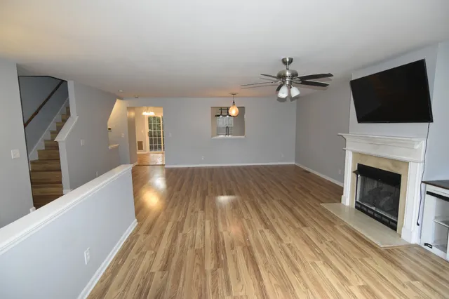 a view of a livingroom with an empty space and a fireplace