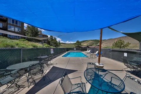 a view of yard from deck with patio