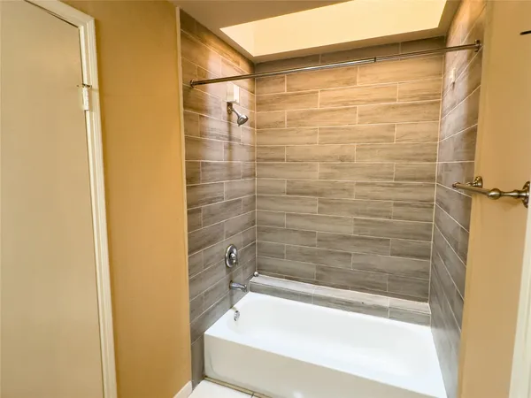 a bathroom with a shower and a bath tub