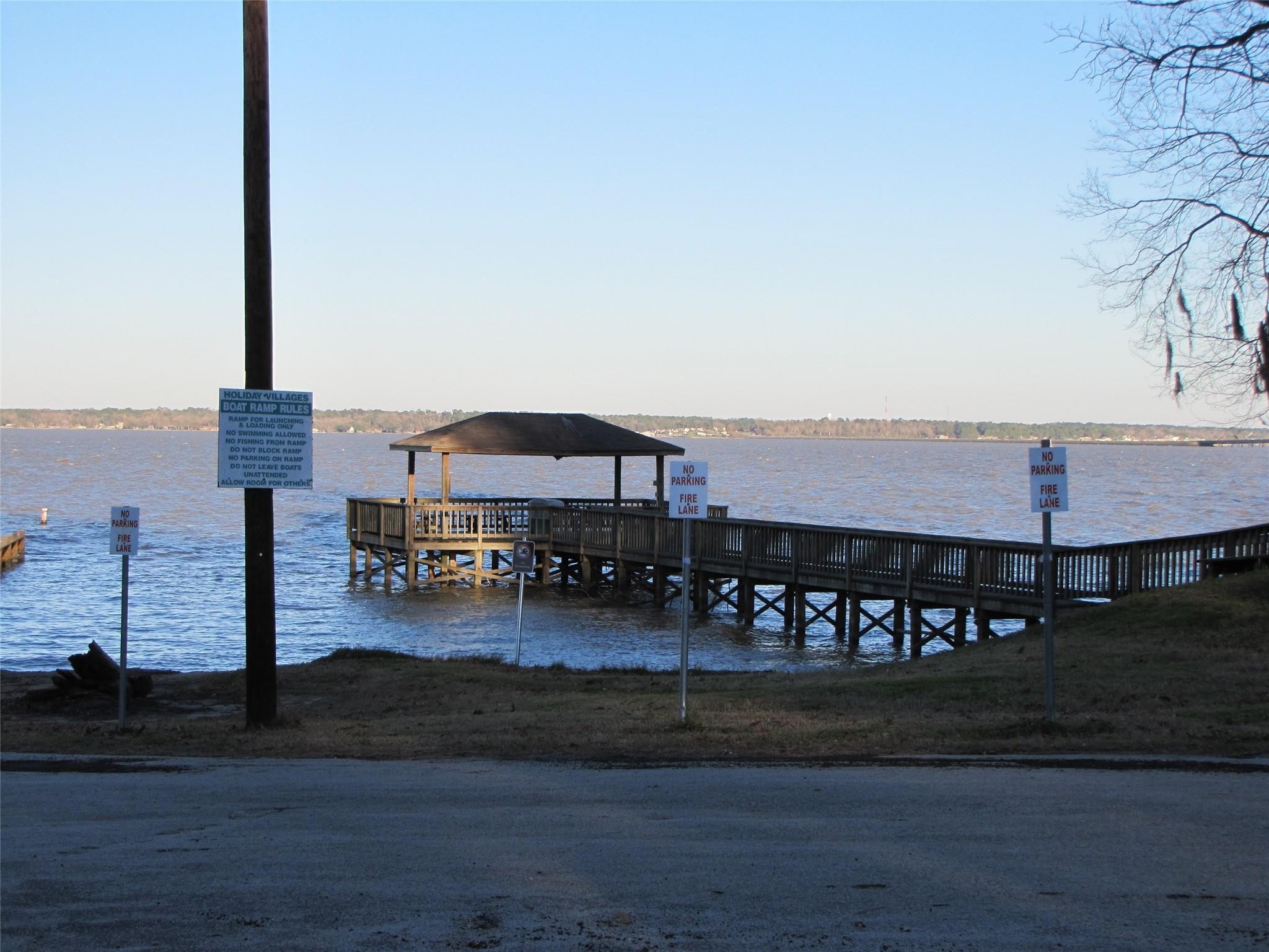 661 Lagoon Drive Point Blank, TX 77364 - Photo 13 of 14 a front view of a building with lake view and trees