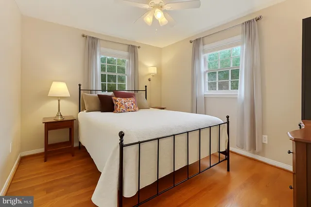 a bed sitting in a bedroom next to a window